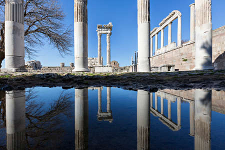 Reflections of the columns of the Temple of Trajan in puddle, in the Roman ruins of Pergamon, known also as Pergamum, in Turkey.の写真素材
