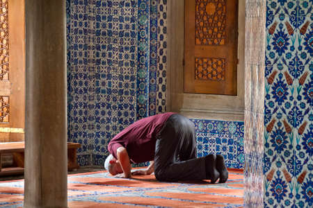 Local man praying in the Rustem Pasha Mosque, in Istanbul, Turkey.