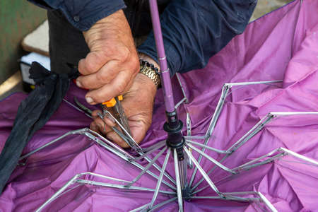 Repairing broken umbrella in Tirana, Albaniaの写真素材