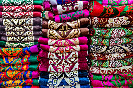 Stack of colorful textiles with traditional motifs, Bishkek, Kyrgyzstan