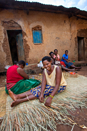 Local women weaving mattress using reeds in Kibale, Ugandaのeditorial素材