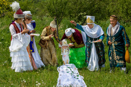 Kazakh women showing local tradition of Tusau Kesu which symbolizes a ceremony that accompanies first steps of a child, in Almaty, Kazakhstanのeditorial素材
