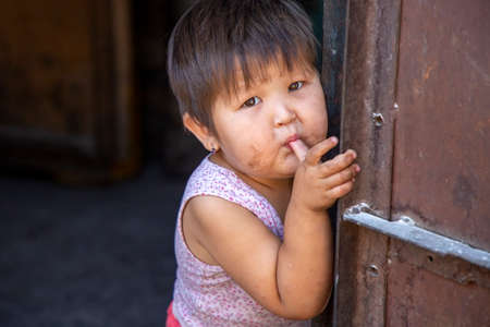 Kyrgyz girl sucking her thumb and posing, Bishkek, Kyrgyzstanのeditorial素材