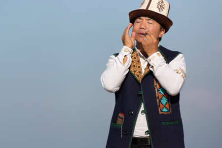 Kyrgyz musician playing traditional musical instrument known as Timur Komuz, a version of jaw's harp, in Issyk Kul, Kyrgyzstanのeditorial素材