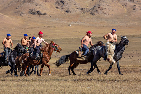 Nomad horse riders playing traditional horse game of Buzkashi known also as Kokpar, in Issyk Kul, Kyrgyzstan.のeditorial素材