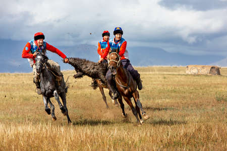 Nomad horse riders playing traditional horse game of Buzkashi known also as Kokpar, in Issyk Kul, Kyrgyzstan.のeditorial素材