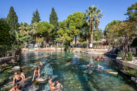 People swimming in the antique pool from Roman era known as "Cleopatra's Pool" in Pamukkale, Turkeyのeditorial素材