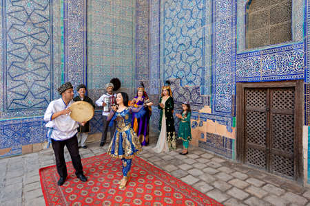 Khorezmian musicians in local dress dance, in Khiva, Uzbekistan.のeditorial素材