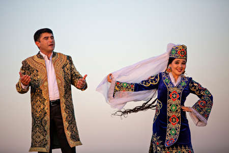 Uzbek man and woman in national costumes dancing and singing in Bukhara, Uzbekistanのeditorial素材