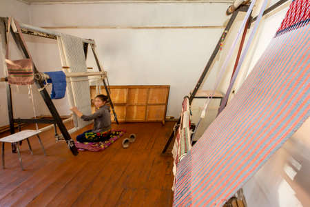Local girl weaving tapestry in Nukus, Uzbekistanのeditorial素材