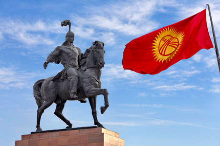 Statue of hero Manas representing the epic of Manas and Kyrgyzstan flag in Alatau Square in Bishkek, Kyrgyzstanのeditorial素材