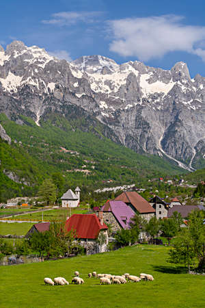 Theth Village with snow capped mountains in the Theth Valley in Albaniaの写真素材