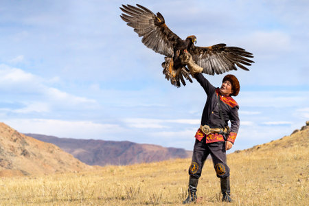 Eagle hunter and his Golden Eagle in Issyk Kul, Kyrgyzstanのeditorial素材