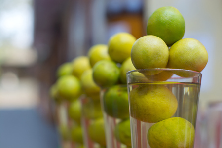 Fresh lemons arranged in glass at storeの写真素材
