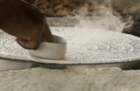 Dosa batter being spread on tawaの写真素材