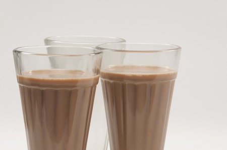 Close-up of chai glasses with an empty glass isolated over white backgroundの写真素材