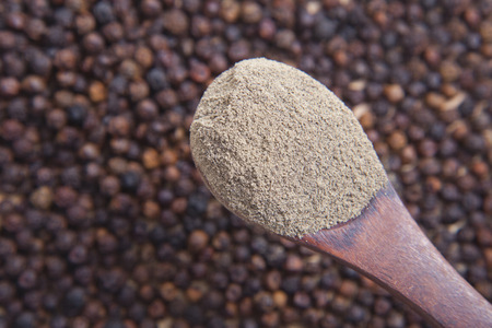 Spoon full of black pepper powderの写真素材