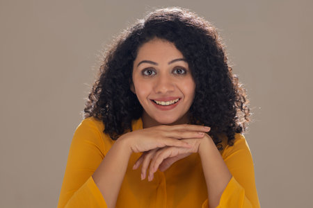 Beautiful young woman looking at camera with smileの写真素材