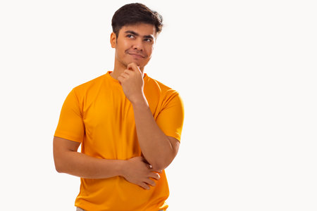 Portrait of young man thinking against white backgroundの写真素材