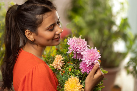 Close-up portrait of a young woman holding a flower bouquet