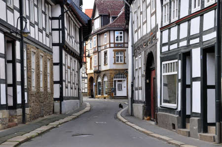 Small street of the old German city of Goslar and a cat on roadの写真素材