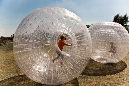 children have a lot of fun in the Zorbing Ballの写真素材