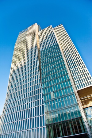 skyscraper in Frankfurt with blue sky and facade in sunの写真素材