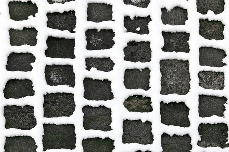 detail of cobble stone paveway in winter with snow on seamの写真素材