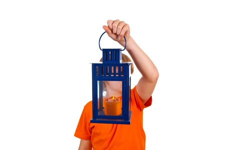 cute boy holding a hand lantern with a candleの写真素材