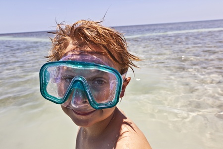 happy boy with swim mask enjoys the  ocean の写真素材