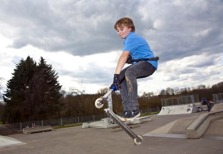boy is going airborne witha scooterの写真素材