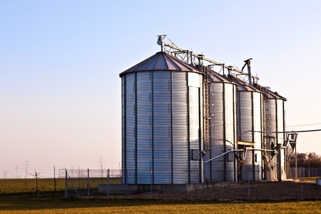silver silos in the fieldの写真素材
