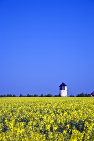 water tower in beautiful landscape with blue skyの写真素材
