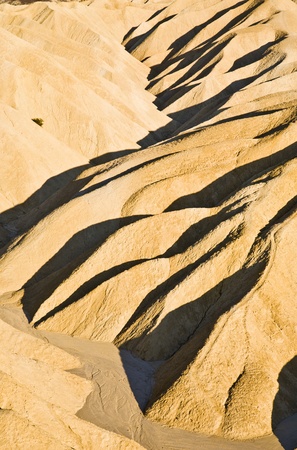 Picturesque soft waves from multi-coloured sandstone. Death valley, Zabriski - a point on a sunsetの写真素材