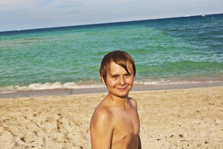 portrait of happy young boy at the beachの写真素材
