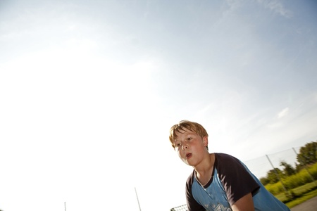 boy with sweating face after sport looks confidentの写真素材