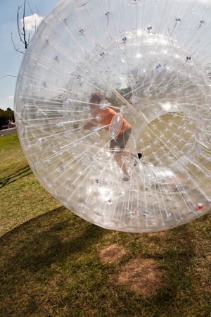 child has a lot of fun in the Zorbing Ballの写真素材