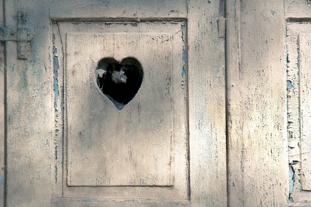 old wooden door in meran, Tirol, Italy with a carved romantic heartの写真素材
