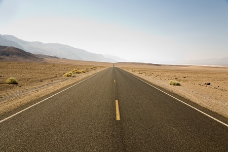 driving on the Interstate 187 in Death valley direction Badwater in the heat of the Mojave Desert