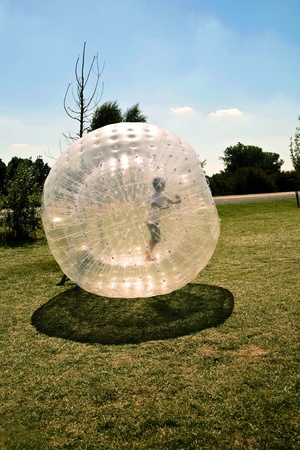 child has a lot of fun in the Zorbing Ballの写真素材