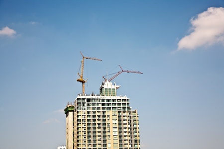 crane on a skyscraper under constructionの写真素材