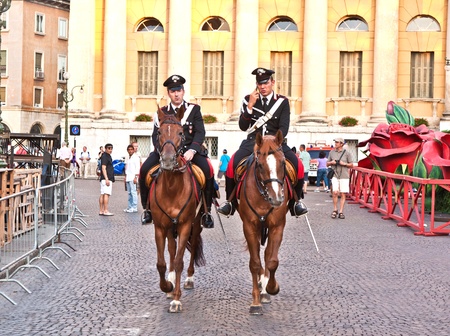 VERONA, ITALY - AUGUST 05: Police on horses are using the mobile and watching and helping the spectators entering the Arena on August 05,2009, Verona, Italy.のeditorial素材