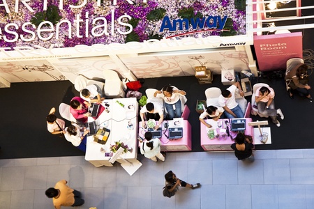 BANGKOK, THAILAND - May 8:  Shopping Mall Central World, Hostesses from AMWAY are advising how to use their products and offering Skin Analysis with Photo and Laptop,  May 8, 2009 in Bangkok, Thailandのeditorial素材