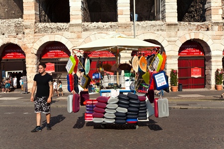 VERONA, ITALY - AUGUST 5: seat cushions are sold in front of the famous old roman Arena of Verona on August 5,2009 in Verona, Italyのeditorial素材