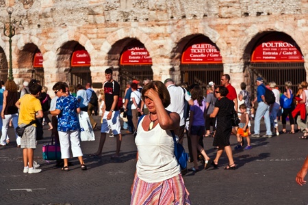 VERONA, ITALY  - AUGUST 04: visitors, spectators are waiting outside the arena di verona for entrance in the opera late afternoon on  August, 04,2009 Verona, Italyのeditorial素材