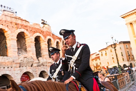 VERONA, ITALY - AUGUST 05: Police on horses are using the mobile and watching and helping the spectators entering the Arena on August 05,2009, Verona, Italy.のeditorial素材