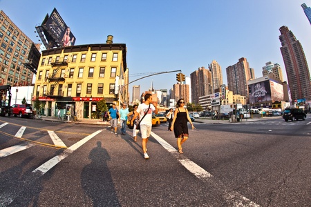 NEW YORK CITY - JULY 8:  Cityview of New York from the eastside of the harbor in late afternoon light on July 8, 2010 in Manhattan, New York City. Tourists crossing a street on their city tour.のeditorial素材