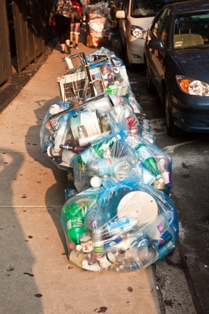 NEW YORK CITY - JULY 8:  litter placed on the street in blue plastic sacks to be ready for garbage collection on the same day  on July 8, 2010 in Manhattan, New York City.のeditorial素材