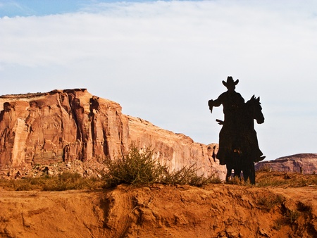 Cowboy on a Horse Silhouette in the Monument Valleyの写真素材