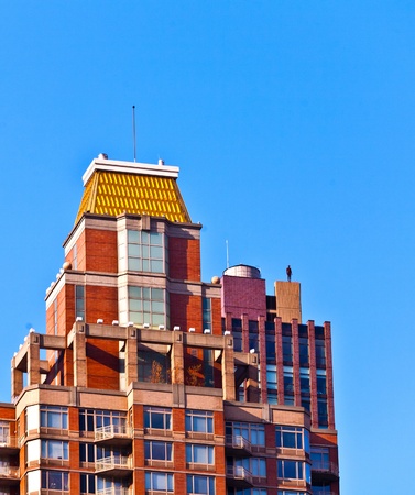 NEW YORK, USA - JULY 7: Facade of Empire State Building in the afternoon with iron statue of Man from atist Antony Gormley on the roof on July 7,2010 in New York, USA.のeditorial素材